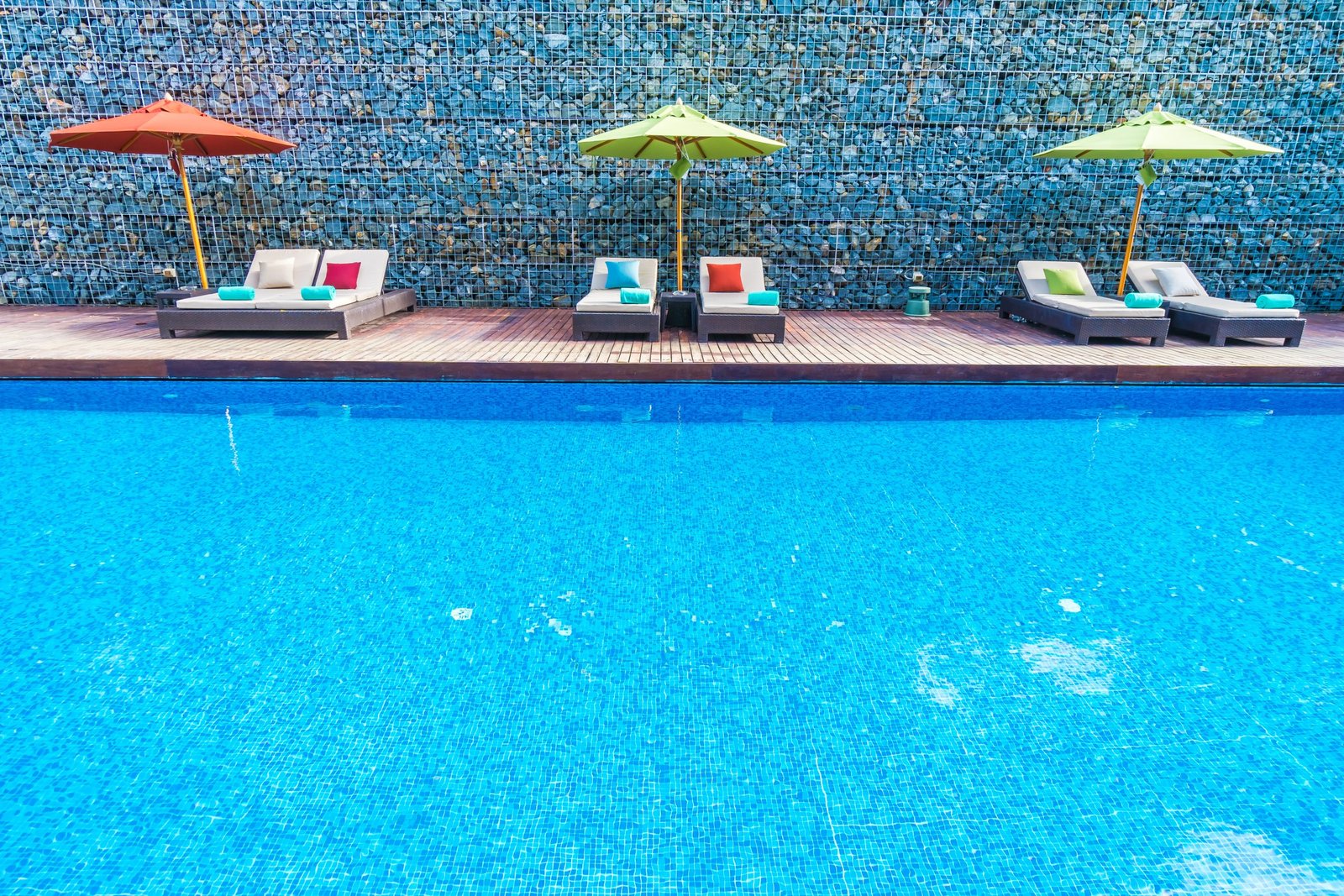 Umbrella and chair around swimming pool in beautiful luxury hotel resort for holiday vacation concept background